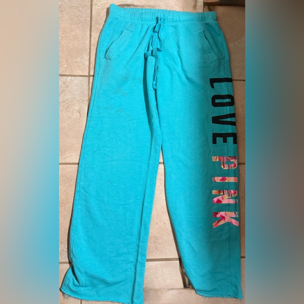 Victoria's Secret Turquoise Pants with Black and Pink Lettering has stains